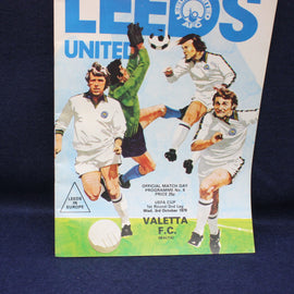 Vintage soccer match program for Leeds United against Valletta FC on a dark blue background