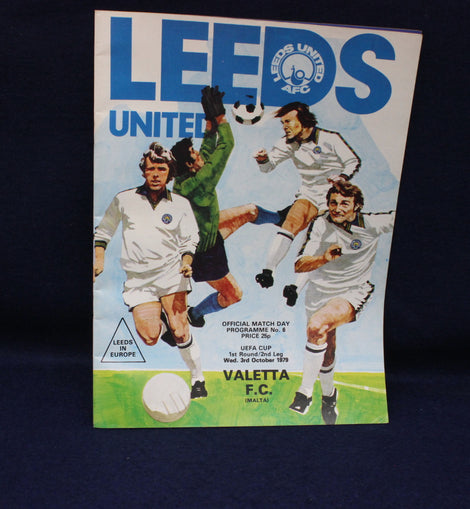 Vintage Leeds United football program with player illustrations on a dark background