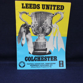 Leeds United vs Colchester match program with a trophy on a yellow and blue background