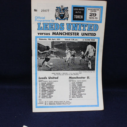 Vintage football match programme between Leeds United and Manchester United on a dark background