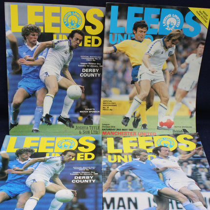 Four soccer match programs featuring Leeds United players and matches against Derby County and Manchester United.