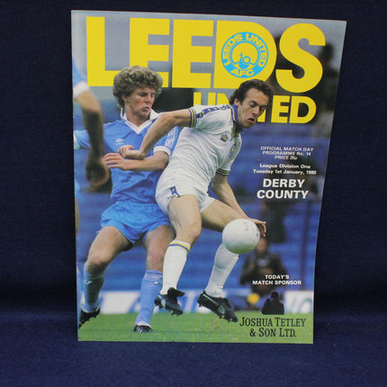 Soccer match program for Leeds United vs Derby County with players in action on cover
