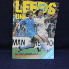 Soccer match program cover featuring two players from Leeds United and Nottingham Forest on a dark background