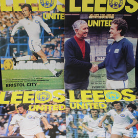 Collage of Leeds United football program covers from different matches.
