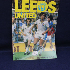 Vintage football match programme for Leeds United vs Norwich City featuring a player in action.