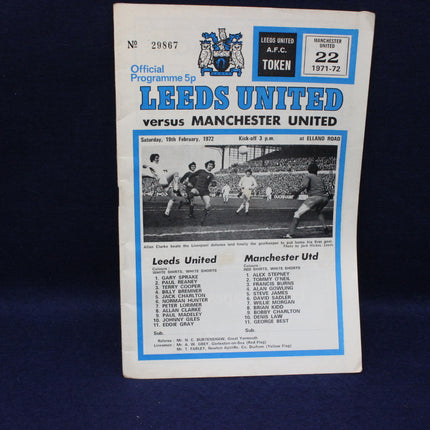 Vintage football programme for Leeds United vs Manchester United match, featuring team line-ups and match details.