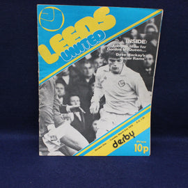 Vintage sports program cover for Leeds United with a player image and text on a blue background