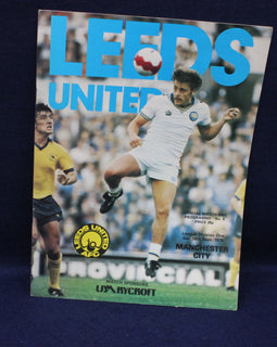 Soccer match program for Leeds United featuring a player in action on a blue background