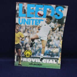 Soccer match program for Leeds United featuring a player in action on a blue background