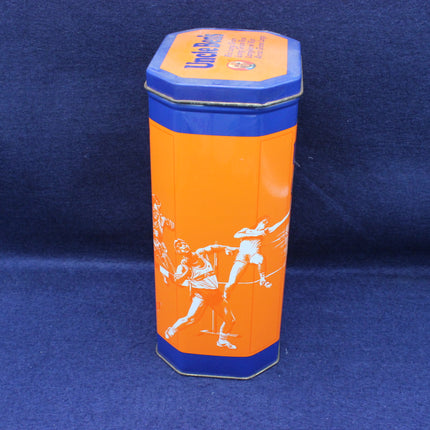 Hexagonal tin can with orange body and blue lid on a blue background