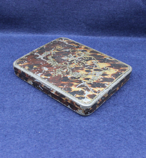 Vintage tortoiseshell case on a blue background