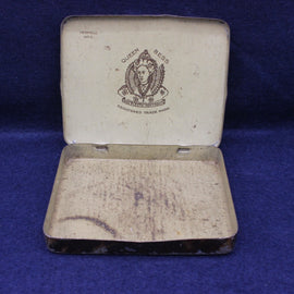 Vintage Queen Bess tin on a blue background