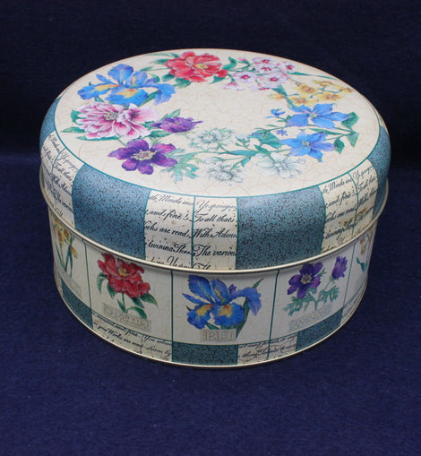 Round decorative box with floral patterns on a dark blue background