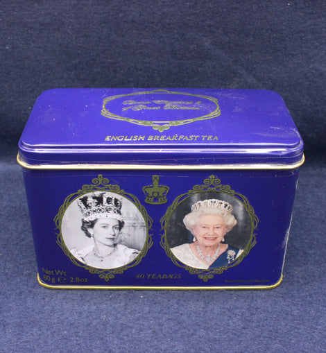 Blue tea tin with portraits of a monarch on a dark blue background