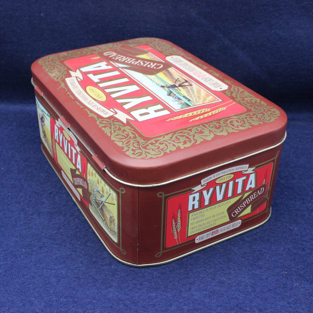 Ryvita cracker tin with branding on a blue background
