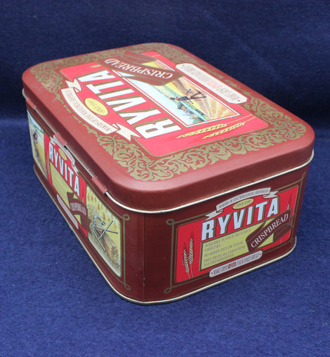 Ryvita cracker tin with branding on a blue background