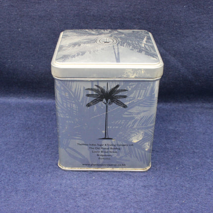 Rectangular metal tin with palm tree design on a blue background