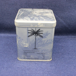 Rectangular tin with palm tree design on a blue background