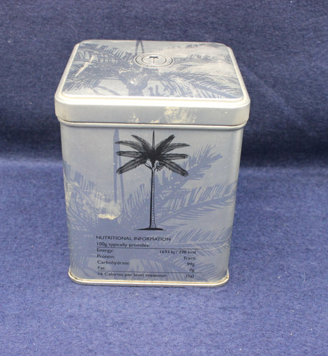 Rectangular tin with palm tree design on a blue background