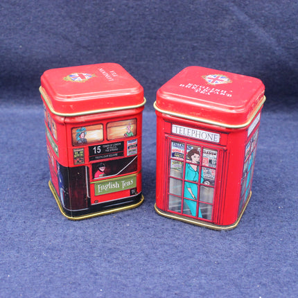 Two red tea tins designed like British telephone boxes on a blue background