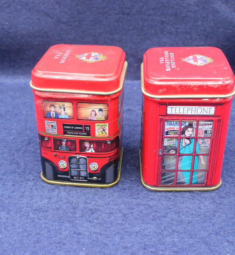 Two red tins with London-themed designs on a blue background