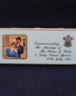 Memorabilia tin commemorating the marriage of Prince Charles and Lady Diana Spencer on a dark background