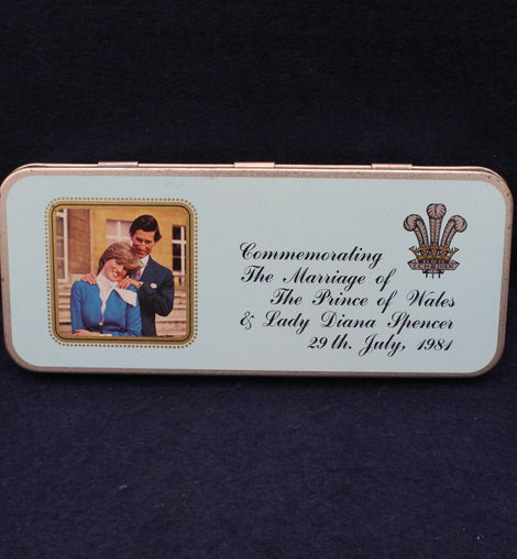 Memorabilia tin commemorating the marriage of Prince Charles and Lady Diana Spencer on a dark background