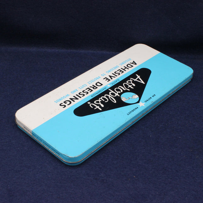 Blue and white adhesive dressing packaging on a dark blue background