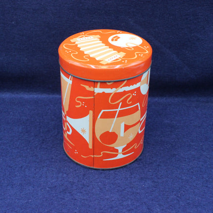 Decorative cylindrical tin with orange lid and colorful design on a blue background