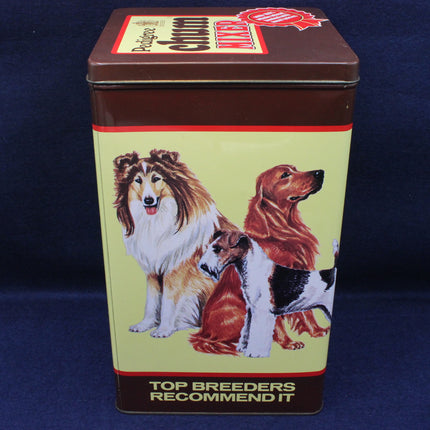 Tin box with images of dogs and text on a blue background