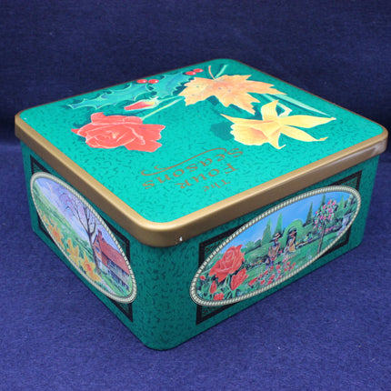 Decorative tin box with floral designs on a blue background