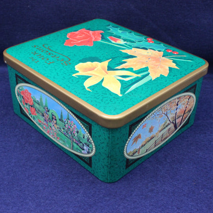 Decorative tin box with floral designs on a blue background