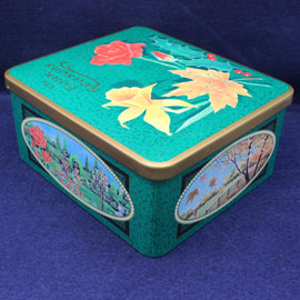 Decorative tin box with floral designs on a blue background