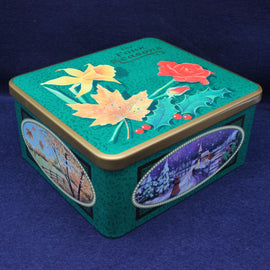 Decorative tin box with floral and landscape designs on a blue background