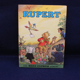 Rupert Annual book cover with cartoon characters on a blue background