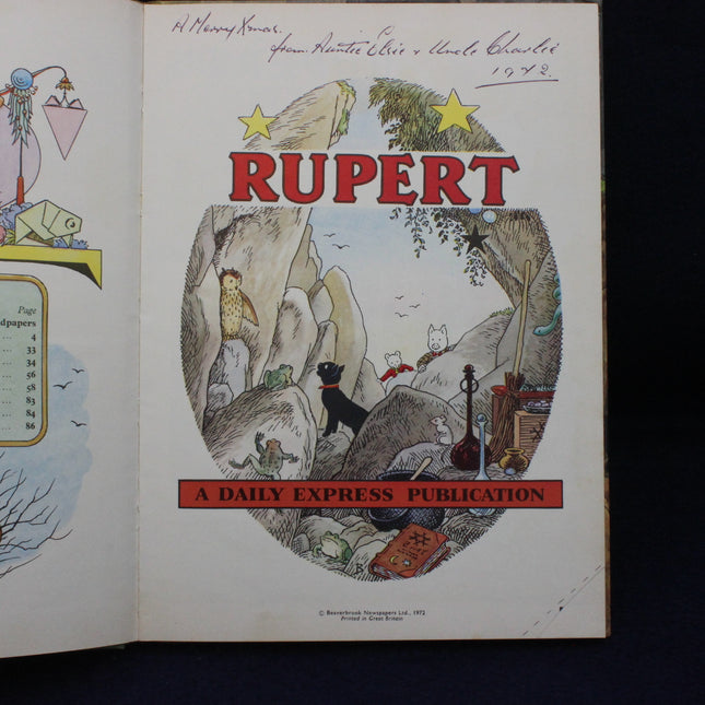 Rupert the Bear illustration from a Daily Express publication, featuring Rupert in a cave with various animals and objects.