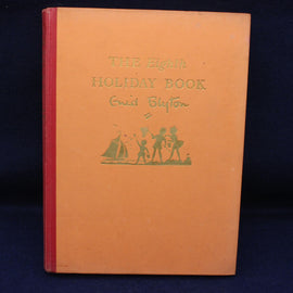 Book titled 'The Eighth Holiday Book' by Enid Blyton with a red spine on a dark background