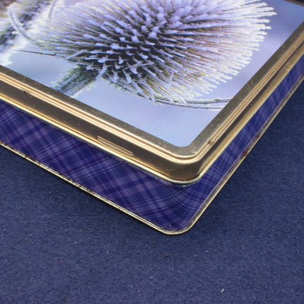 Close-up of a decorative box with a floral design on a blue fabric background