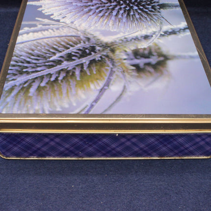 Close-up of a decorative box with a floral design on a blue surface