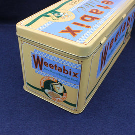 Weetabix cereal tin with colorful branding on a blue background