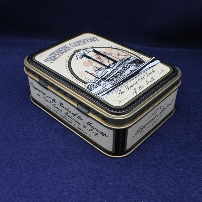 Vintage-style tin box with decorative lid on a blue background