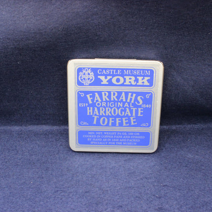 Tin of Farrahs Harrogate Toffee on a dark blue background