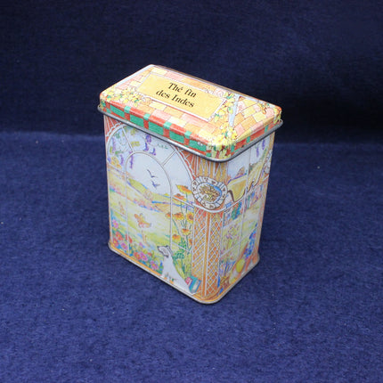Colorful tin box with decorative design on a blue background