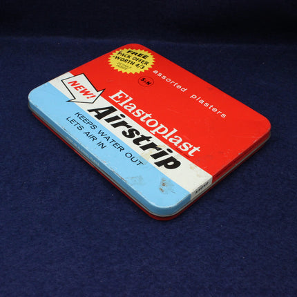 Vintage Airstrip Elastoplast packaging on a dark blue background