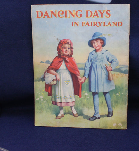 Book cover titled 'Dancing Days in Fairyland' with illustrations of two children on a blue background