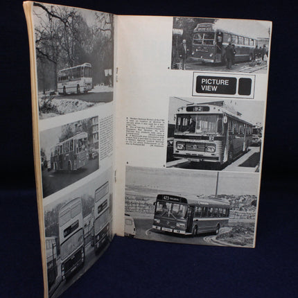 Open book with black and white photographs of buses on a dark background