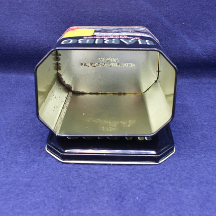 Metallic octagonal object with reflective surface on a blue background