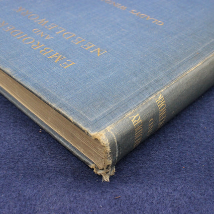 Vintage blue book with gold text on a matching blue background