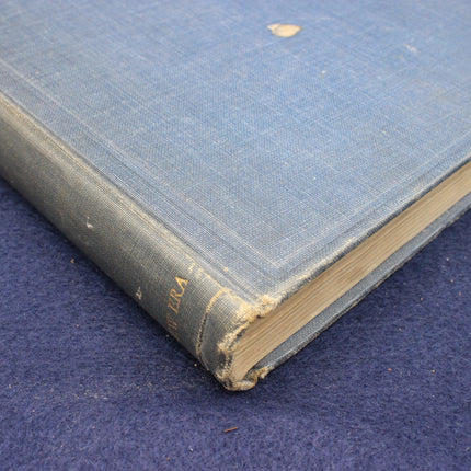 Vintage blue book with worn corners on a dark blue background