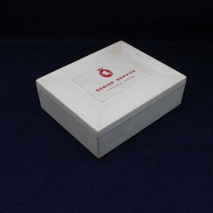 White box with 'Senior Service' label on a dark background
